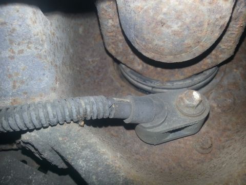 1994 Ford Bronco - Close-up of a vehicle's ABS sensor and mounting bracket, showing rust on surrounding parts.