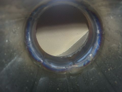 1994 Ford Bronco - Close-up view inside an exhaust pipe, showing a mesh screen.