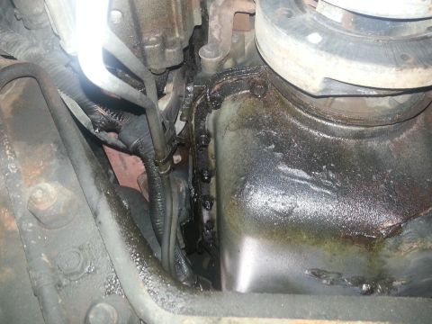 1994 Ford Bronco - Engine oil pan and transmission bell housing showing signs of oil leakage and wear.