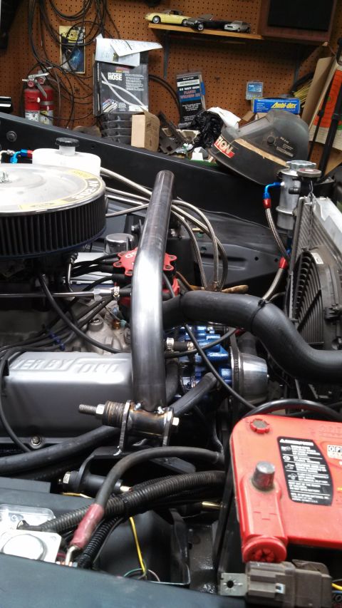 1967 Ford F-250 - Close-up view of a modified engine bay, showing various components and custom work.