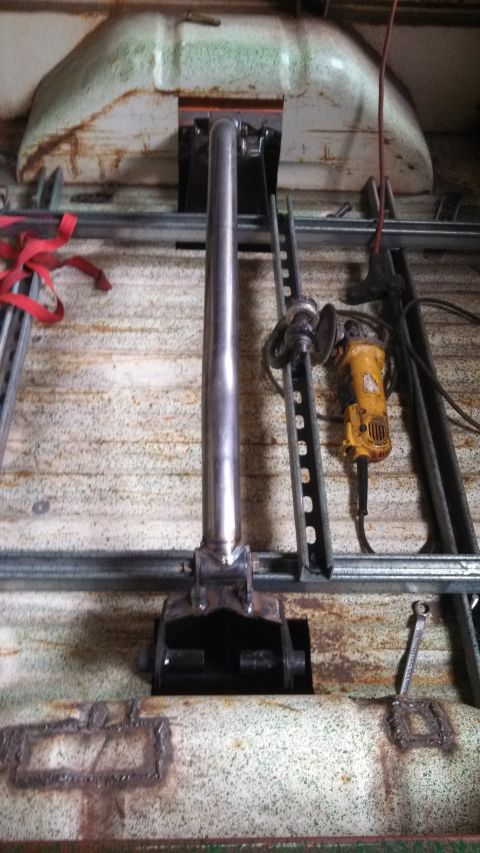 1967 Ford F-250 - The interior of a truck bed shows a jack mechanism, an angle grinder, and various metal components, suggesting ongoing work.