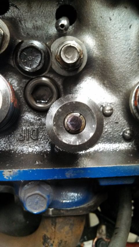 1967 Ford F-250 - Detail of an engine component, showing mechanical parts and cast metal.