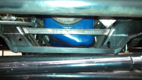1967 Ford F-250 - Underside view of a vehicle, focusing on the blue oil pan and frame structure.