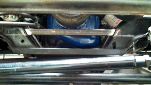 1967 Ford F-250 - Close-up of the undercarriage, showing the engine and some suspension parts.