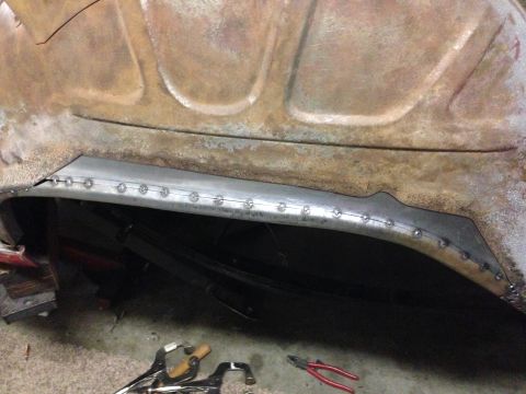 1964 Ford Fairlane - Metalwork in progress on a vehicle's body panel, showing new riveted sections.