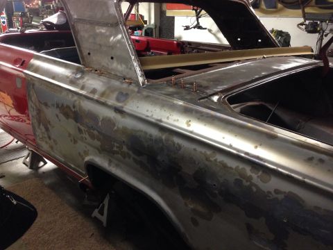 1964 Ford Fairlane - A 1964 Ford Fairlane is shown with its body panels stripped to bare metal, indicating restoration work.