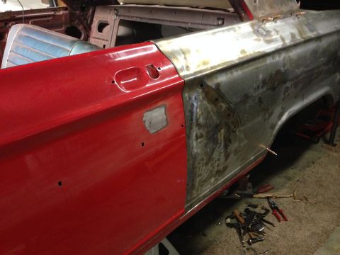 1964 Ford Fairlane - Side view of a red car door and fender undergoing repairs, with tools scattered nearby.