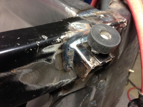 1964 Ford Fairlane - Close-up view of a welded frame section a rubber bumper and visible metalwork.