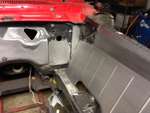 1964 Ford Fairlane - Close-up of a car's firewall and inner fender during restoration or repair work.