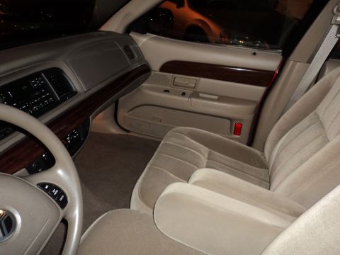 2004 Mercury Grand Marquis - The interior of a 2004 Mercury Grand Marquis features wood trim and plush seating.