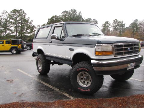1979 Ford Bronco - This Ford Bronco is parked next to a yellow Jeep. The Bronco appears to be from the early 1990s.