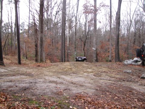1979 Ford Bronco - Off-roading scene with two vehicles in a wooded area.