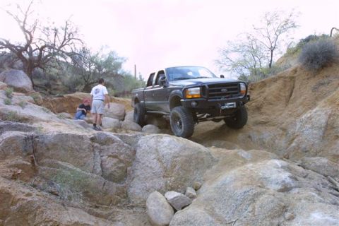 1994 Ford Bronco - Ford F-Series truck tackling a challenging rocky terrain off-road.