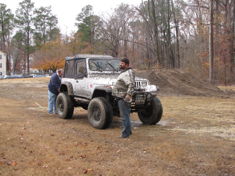 White Jeep Wrangler with large tires and off-road modifications