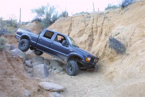 1994 Ford Bronco - This Ford F-250 is attempting to climb a steep, rocky incline in a desert environment.