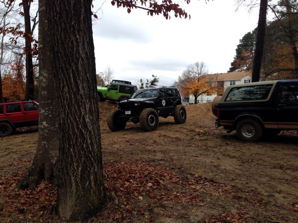 Black and tan Ford Bronco parked on a dirt hill