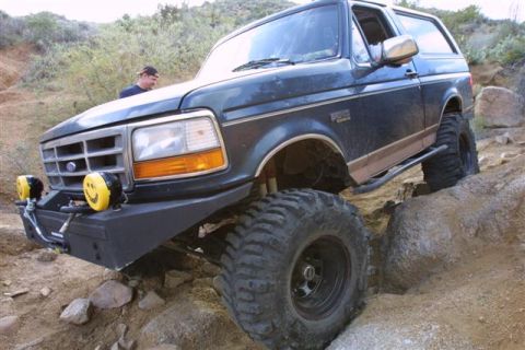1994 Ford Bronco - This 1994 Ford Bronco navigates a rocky trail, its off-road capabilities with large tires and a lifted suspension.