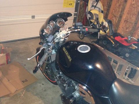 1998 Suzuki Bandit - A black Suzuki motorcycle is parked in a garage, with a ladder and other items in the background.