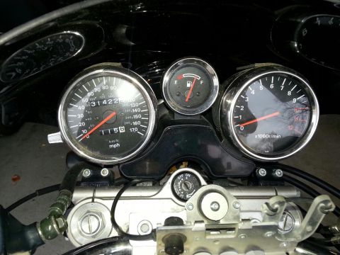 1998 Suzuki Bandit - The dashboard of a motorcycle features a speedometer, tachometer, and fuel gauge, with the speedometer indicating 31,422 miles.