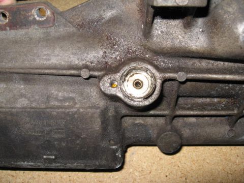 1966 Ford Falcon - Close-up of a cast metal automotive part, possibly from a transmission, showing a threaded fitting.