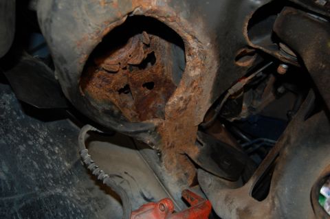 1985 Mercury Grand Marquis - Severe rust damage is evident on this vehicle's undercarriage component.