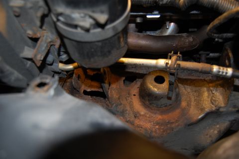 1985 Mercury Grand Marquis - This image shows a close-up view of rusty engine components and hoses, with a Supermotors.net watermark.