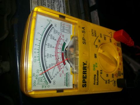 1994 Ford Bronco - Close-up of a yellow Sperry SP-5A analog multimeter, showing its dial and needle.