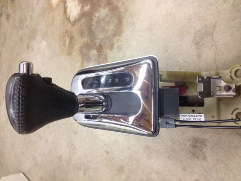 1998 Ford Crown Victoria - automatic shifter assembly with leather knob and chrome PRND21 bezel, the base carrying a printed wiring label.