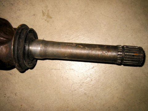 1985 Ford Bronco - Close-up view of a driveshaft component, showing the splined end and a rubber boot.