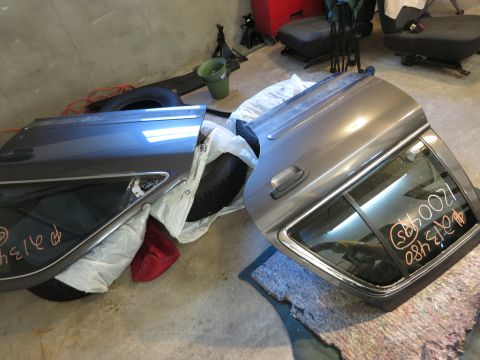 1991 Ford LTD Crown Victoria - Photograph of detached car doors on a garage floor, not a document.