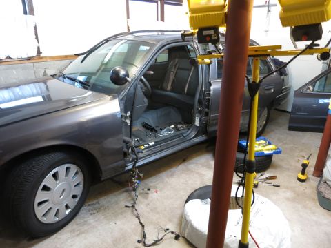 1991 Ford LTD Crown Victoria - Photograph of a sedan being worked on in a garage, not a document.