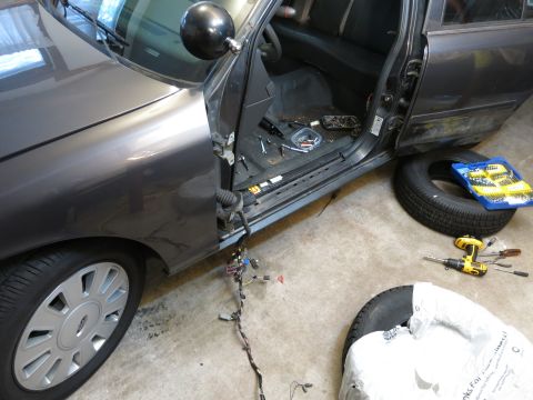 1991 Ford LTD Crown Victoria - Photograph of a car teardown with exposed sill and wiring harness, not a document.
