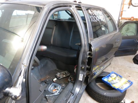 1991 Ford LTD Crown Victoria - Photograph of a car rear interior during teardown, not a document.