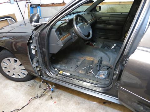 1991 Ford LTD Crown Victoria - Photograph of a stripped car interior with wiring harness, not a document.