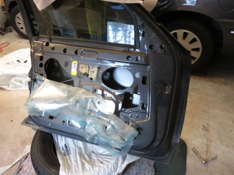 1991 Ford LTD Crown Victoria - Photograph of a car front door with the trim panel removed, not a technical document.
