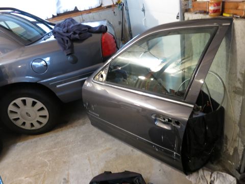 1991 Ford LTD Crown Victoria - Photograph of a removed sedan front door, not a technical document.