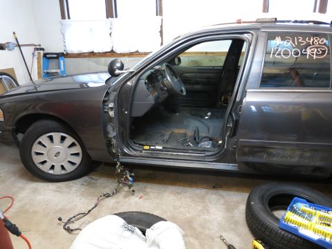 1991 Ford LTD Crown Victoria - Photograph of a Crown Victoria mid-disassembly in a garage, not a technical document.