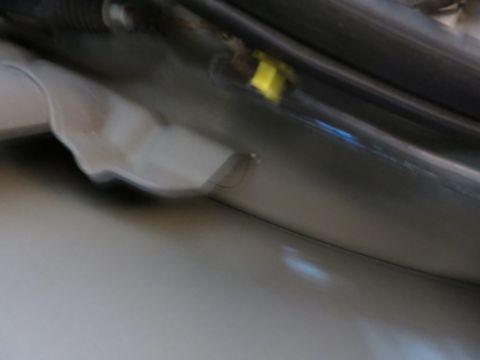 1991 Ford LTD Crown Victoria - Blurry photograph of a vehicle door hinge area, not a technical document.