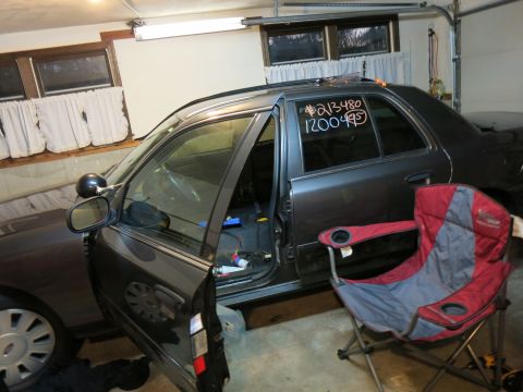 1991 Ford LTD Crown Victoria - Photograph of a sedan during teardown in a garage, not a technical document.