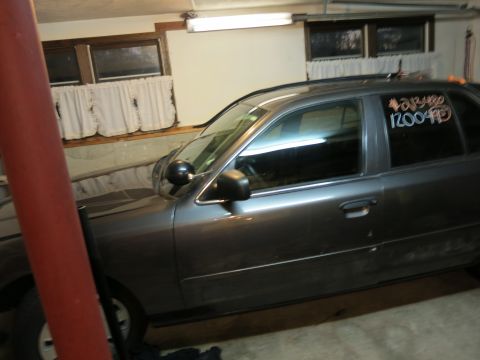 1991 Ford LTD Crown Victoria - Photograph of a sedan parked in a garage, not a technical document.