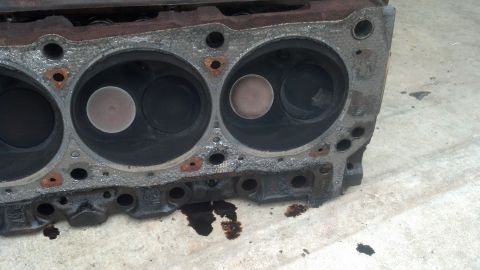 1988 Ford Bronco - This is a close-up view of the cylinder head of a V8 engine, likely from a 1988 Ford Bronco. The head shows four cylinders, two of which ar…