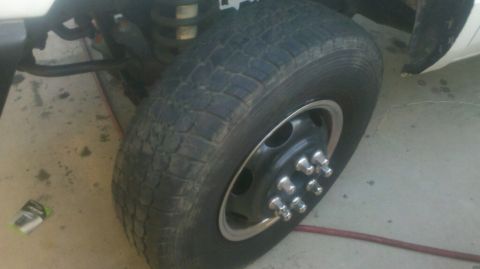 1997 Dodge 3500 - Close-up of the front wheel and suspension on a 1997 Dodge 3500 dually truck.