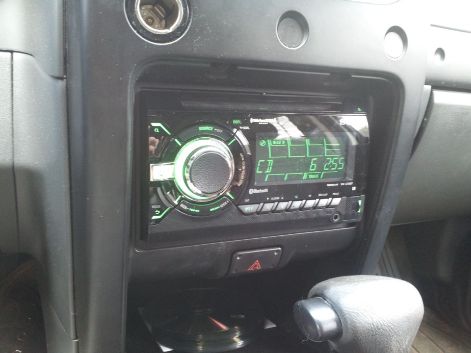 Close-up of a car stereo with a green display showing time 6:25.