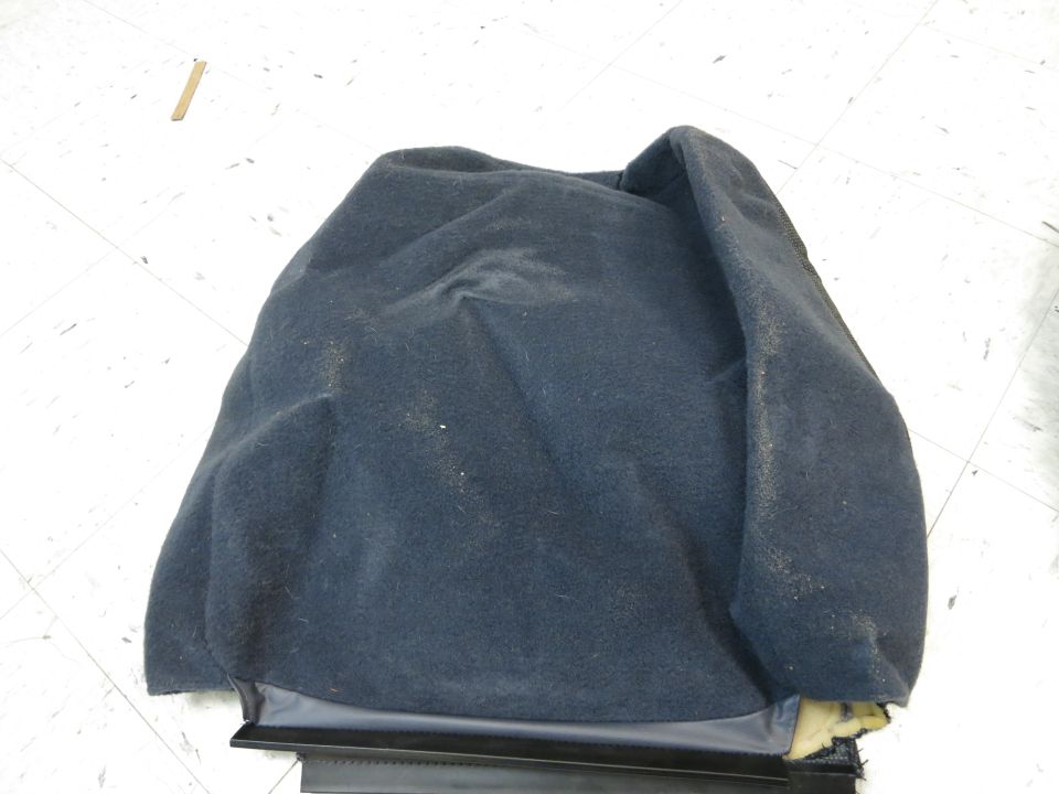 Dark blue car seat cushion, possibly for a rear seat, with visible foam padding on the right side