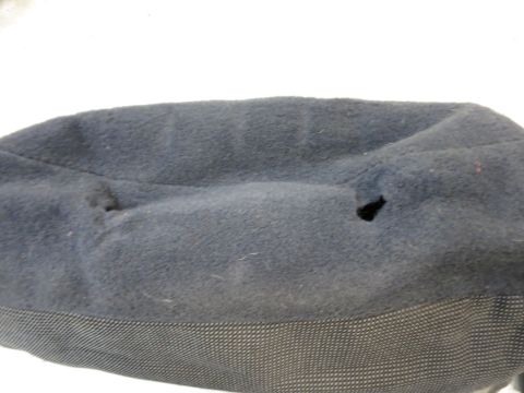 2001 Ford Crown Victoria - A close-up view of a dark blue fabric part, showing two visible holes and a textured lower band.