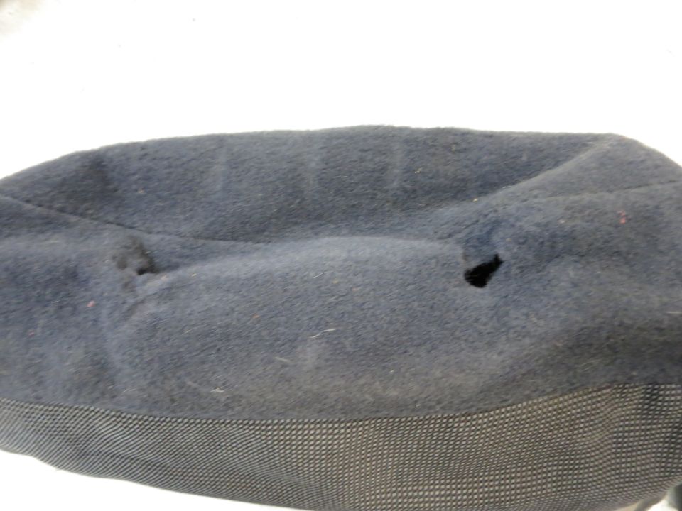 Dark blue fabric part with two holes and a textured lower section