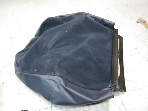 2001 Ford Crown Victoria - A detached car seat cushion lies on a tiled floor, showing its internal structure and fabric.