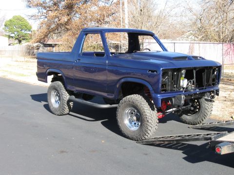 1982 Ford Bronco - This lifted 1982 Ford Bronco features a custom hood and is shown from a 3q-front perspective.