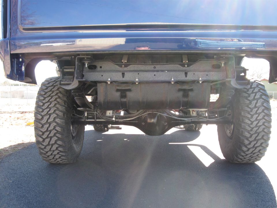 Blue SUV rear axle, suspension, and large tires