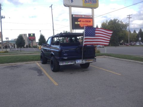 1996 Ford Bronco - Rear view of a 1996 Ford Bronco flying an American flag.